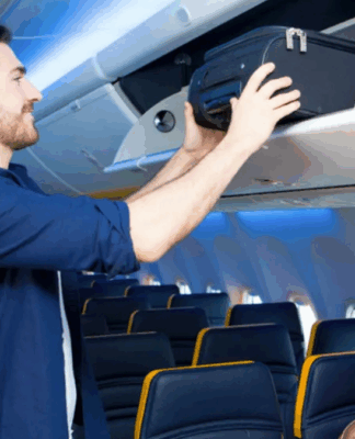 Homem guardando mala de mão no bagageiro do avião