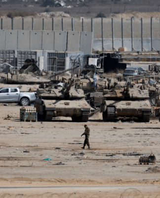 Foto panorâmica em Gaza; tanques e soldados do exército de Israel passam pela área