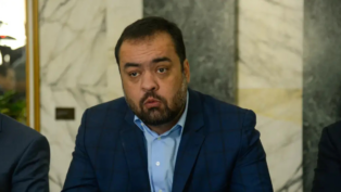 O governador Cláudio Castro está sentado em evento público