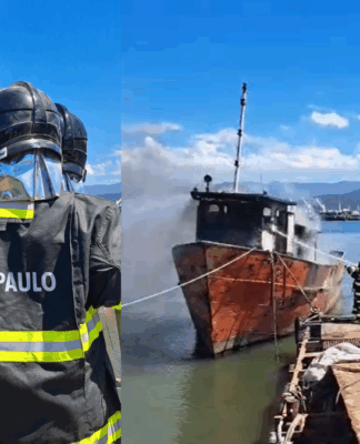 Bombeiros de São Paulo combatem incêndio em embarcação atracada em marina, usando mangueiras para resfriar a estrutura.