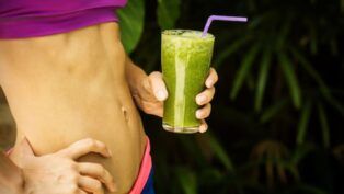 Barriga malhada e copo de suco vere detox