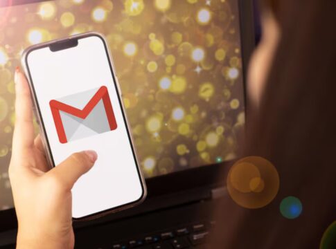 Mão segurando o celular com o logo do Gmail