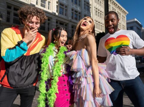 Em imagem ilustrativas há algumas pessoas com roupas coloridas e felizes.