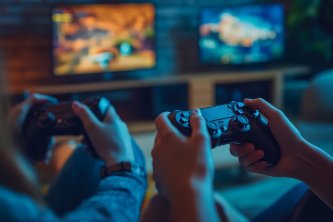 Em imagem ilustrativa, jovens jogam videogame.