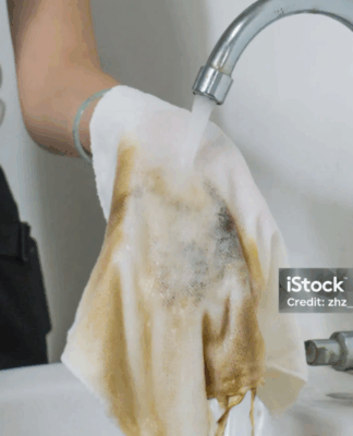 Pessoa lavando pano sujo.