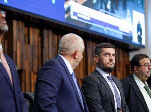 Presidente da Alerj, Rodrigo Bacellar olha para cima ao lado de outros deputados na mesa da assembleia