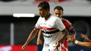 Atleta Luiz Gustavo, do São Paulo, disputando bola com um jogador do Internacional