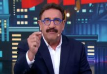 Apresentador Ratinho gesticula ao falar ao microfone