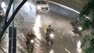 Motos e carros durante fortes chuvas em São Paulo