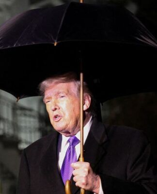 O presidente dos Estados Unidos, Donald Trump, segura um guarda-chuva enquanto fala com jornalistas ao deixar a Casa Branca com destino à Flórida