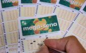 Mega-Sena Uma mão assinala números na cartela da Mega-Sena