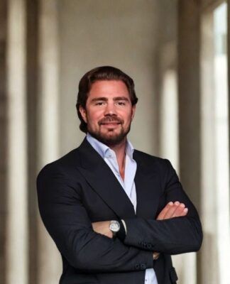 Daniel Vorcaro, fundador do Banco Master, aparece de braços cruzados