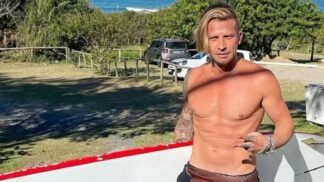 Ex-modelo carrega prancha de surfe