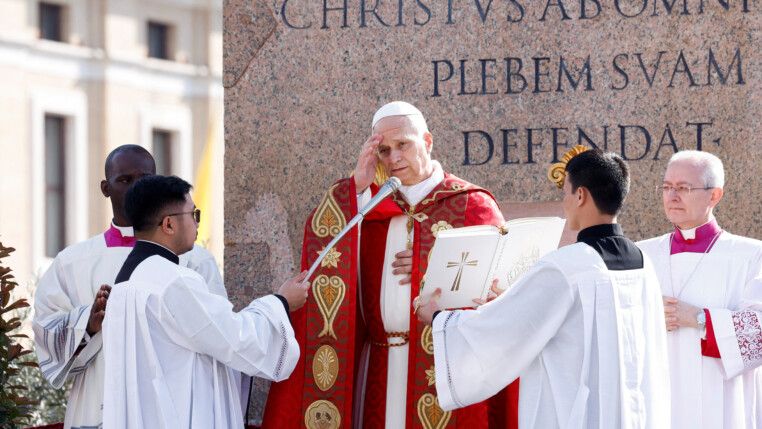 Papa Leão 14 coloca a mão direita sobre a testa durante a missa