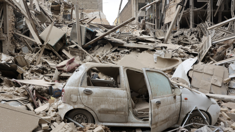 Veículo destruído em meio a escombros no local de um ataque a um prédio residencial, em meio ao conflito entre EUA e Israel contra o Irã, em Teerã