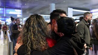 Passageiros evacuados do Oriente Médio se abraçam em aeroporto em Luxemburgo