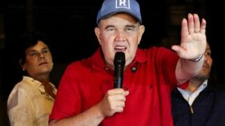 Peru's presidential candidate Rafael Lopez Aliaga speaks as people gather outside Peru's electoral headquarters amid concerns about the voting process during the country's general election, in Lima, Peru, April 14, 2026. REUTERS/Manuel Orbegozo
