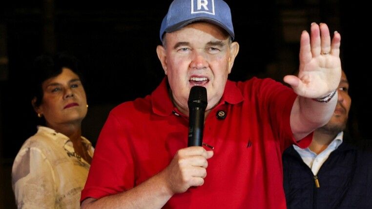 Peru's presidential candidate Rafael Lopez Aliaga speaks as people gather outside Peru's electoral headquarters amid concerns about the voting process during the country's general election, in Lima, Peru, April 14, 2026. REUTERS/Manuel Orbegozo