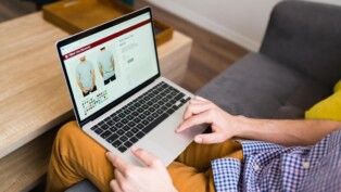 Homem adulto fazendo compras online durante um dia de lazer em casa