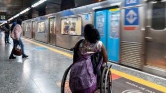 Pessoas esperando metrô na plataforma.