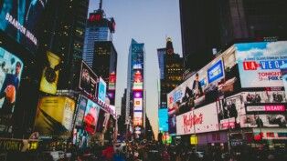 Times Square à noite, com movimentação de pessoas