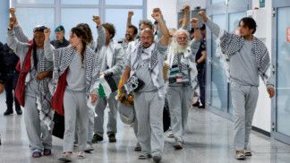Italian activists from the Gaza-bound Global Sumud Flotilla, detained by Israeli forces after their vessels were intercepted in international waters in the Mediterranean, gesture upon arrival at Fiumicino Airport, in Fiumicino, Italy, May 21, 2026. REUTERS/Remo Casilli TPX IMAGES OF THE DAY
