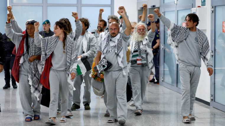 Italian activists from the Gaza-bound Global Sumud Flotilla, detained by Israeli forces after their vessels were intercepted in international waters in the Mediterranean, gesture upon arrival at Fiumicino Airport, in Fiumicino, Italy, May 21, 2026. REUTERS/Remo Casilli TPX IMAGES OF THE DAY