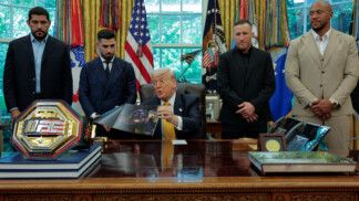 U.S. President Donald Trump shows an image of the concept for the Ultimate Fighting Championship planned for June 14, 2026, as he holds an event with UFC fighters Alex Pereira, Ciryl Gane, Justin Gaethje and Ilia Topuria in the Oval Office at the White House in Washington, D.C., U.S., May 6, 2026. REUTERS/Kylie Cooper