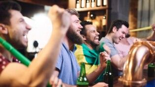 Torcedores assistem a jogo em um bar