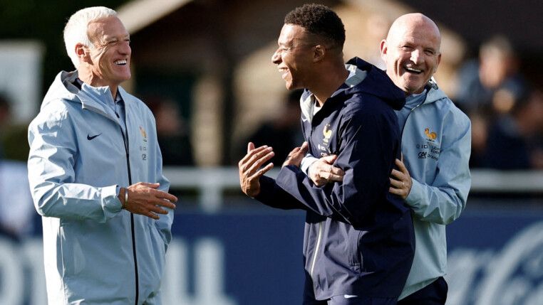 FILE PHOTO: Soccer Football - World Cup - UEFA Qualifiers - France Training - INF Clairefontaine, Clairefontaine-en-Yvelines, France - September 1, 2025 France's Kylian Mbappe reacts with coach Didier Deschamps and assistant coach Guy Stephan during training REUTERS/Benoit Tessier/File Photo