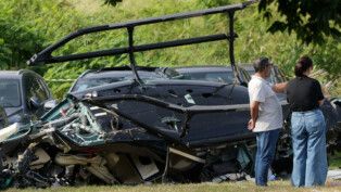 People stand near parts of a helicopter lying on the ground following a deadly collision between two helicopters in Rio de Janeiro, Brazil, June 14, 2026. REUTERS/Ricardo Moraes