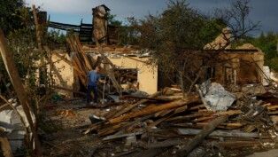 A man stands next to his house, heavily damaged by a Russian missile strike, in the Kyiv region, Ukraine, July 24, 2026. REUTERS/Valentyn Ogirenko