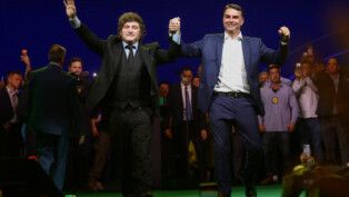 Argentine President Javier Milei and Brazilian Senator Flavio Bolsonaro, who is to be announced as candidate for Brazil's presidential elections, hold hands during the national convention of the Liberal Party (PL) in Sao Paulo, Brazil, July 25, 2026. REUTERS/Jean Carniel