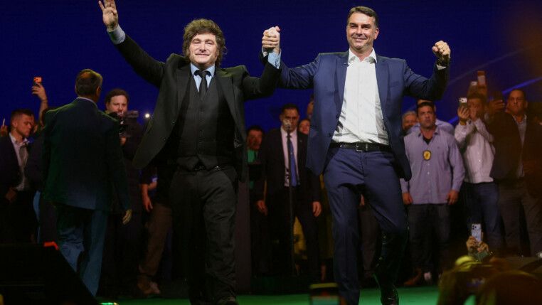 Argentine President Javier Milei and Brazilian Senator Flavio Bolsonaro, who is to be announced as candidate for Brazil's presidential elections, hold hands during the national convention of the Liberal Party (PL) in Sao Paulo, Brazil, July 25, 2026. REUTERS/Jean Carniel