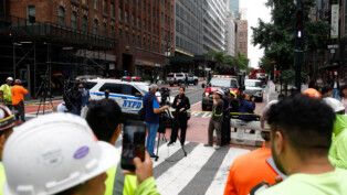 Members of the media work near a building on 42nd Street, which was reported to have structural issues, in New York City, U.S., July 7, 2026. REUTERS/Jordan Tovin