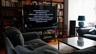 A TV screen shows a black screen with a message that starts "State media cannot lie. We apologise for having done so for years," in Budapest, Hungary, July 7, 2026. REUTERS/Marton Monus