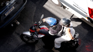 foto mostra condutor e passageira em motocicleta
